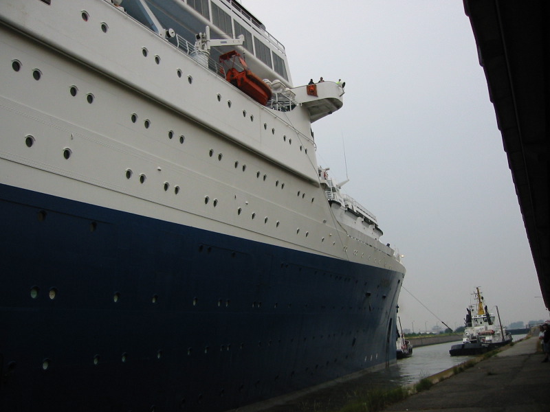 She slowly passes by, still moving towards the locks.